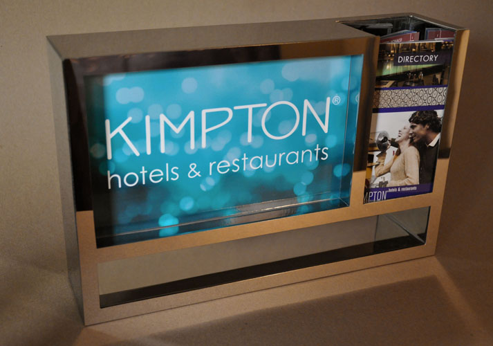 Mirror polished metal literature rack for reception desk at Kimpton Hotels