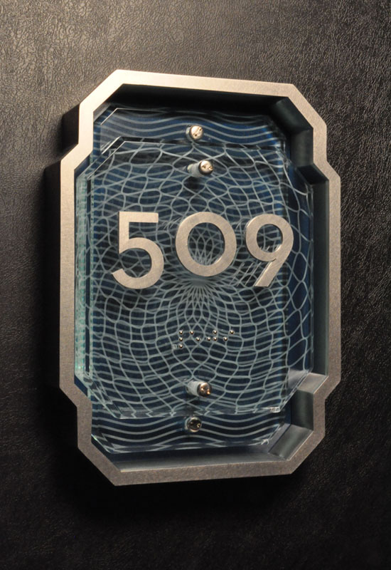 This sign was part of the concept development stage. The hotel project forms a crescent around a man made lagoon off the Persian Gulf, with canals branching off into villas. The concept plays with watch making forms - jeweled glass with guilloche patterns framed by a stark metal geometry.